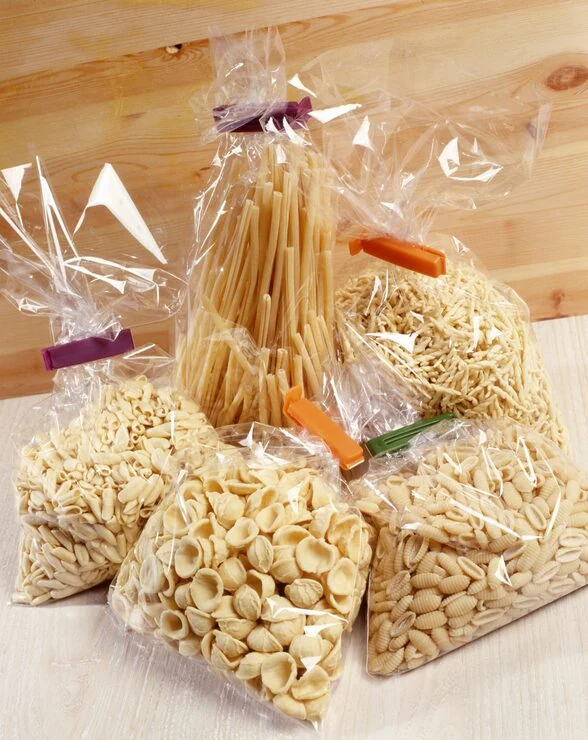 Different pasta shapes in clear bags closed with clips