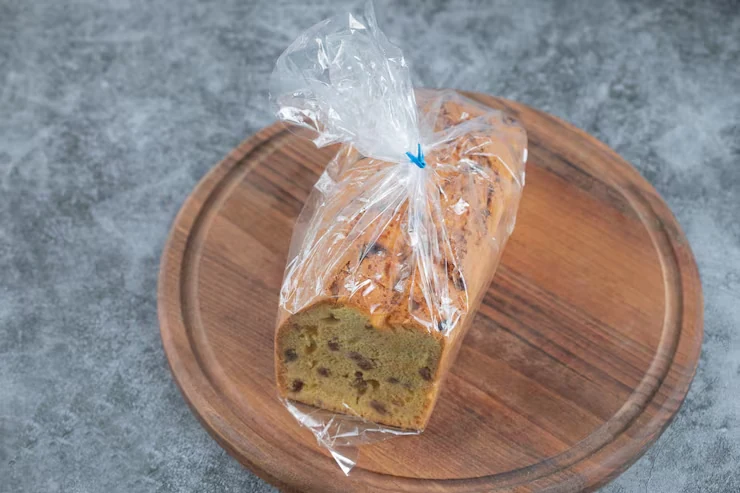 A sliced loaf cake in a clear bag tied with a blue closure