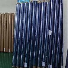 Blue-tinted packaging film rolls standing upright beside empty cardboard cores