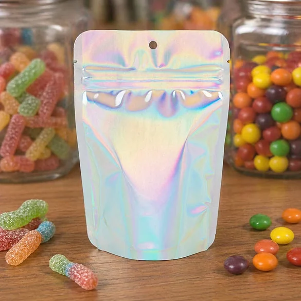 Iridescent silver stand-up zipper pouch with a hang hole beside jars of sweets