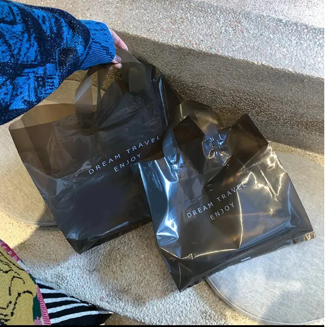 Black printed carry bags displayed on a carpeted floor