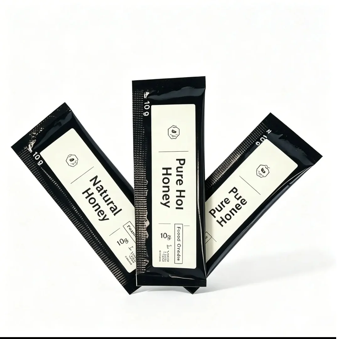 Three black printed honey stick sachets with white labels