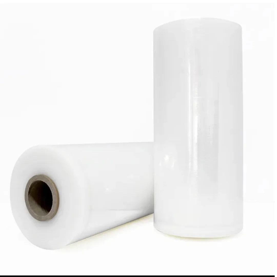 Two clear packaging film rolls with one upright and one lying flat