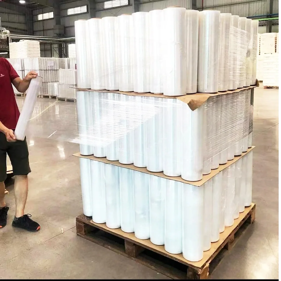 Clear stretch film rolls stacked upright on warehouse pallets