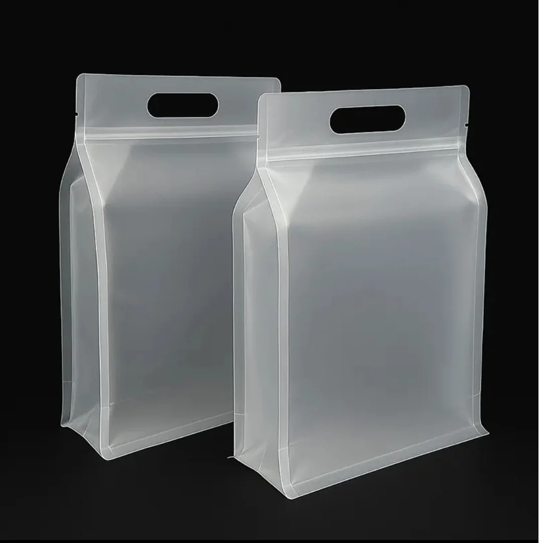 Two empty frosted gusseted pouches with die-cut handles