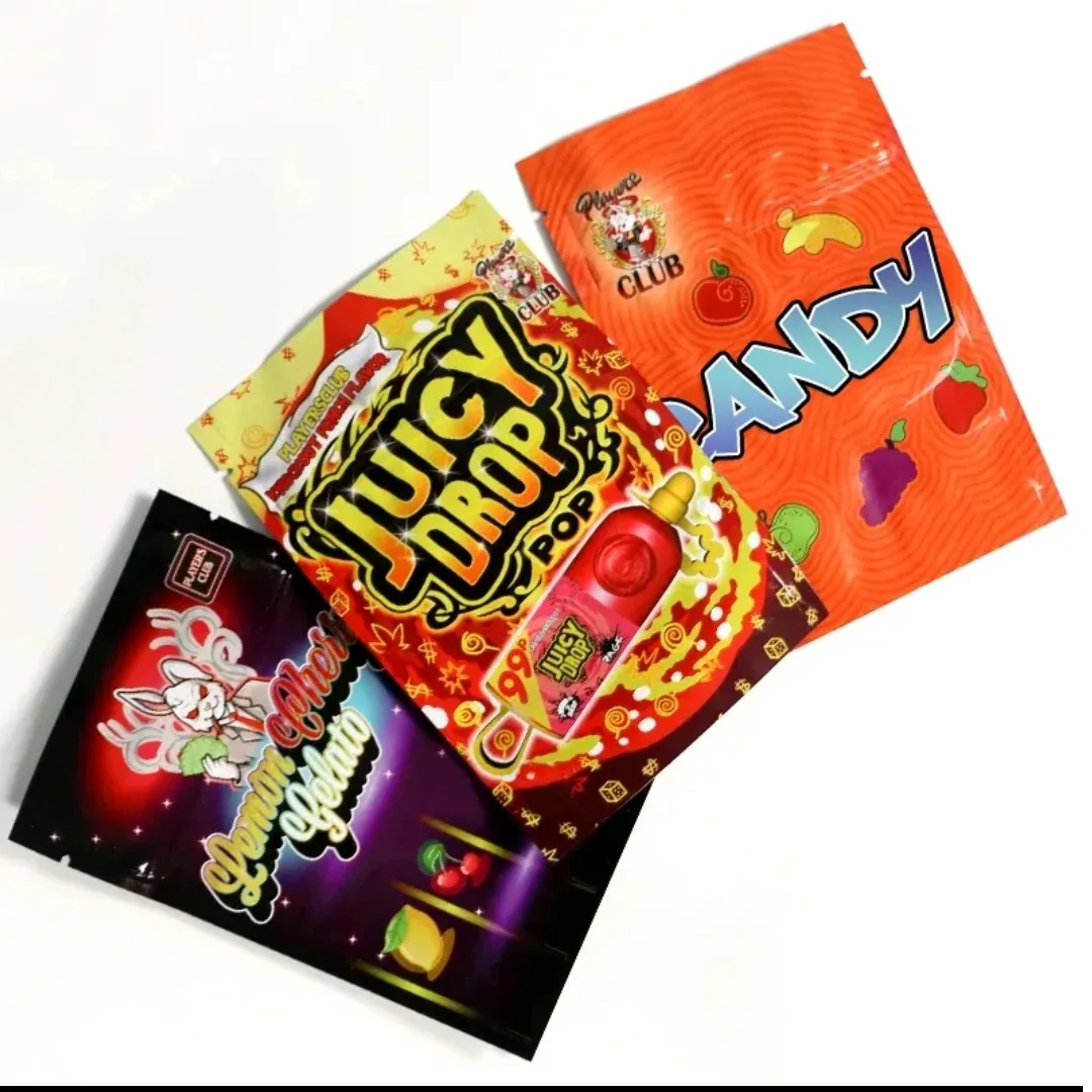 Orange and black printed candy pouches arranged diagonally